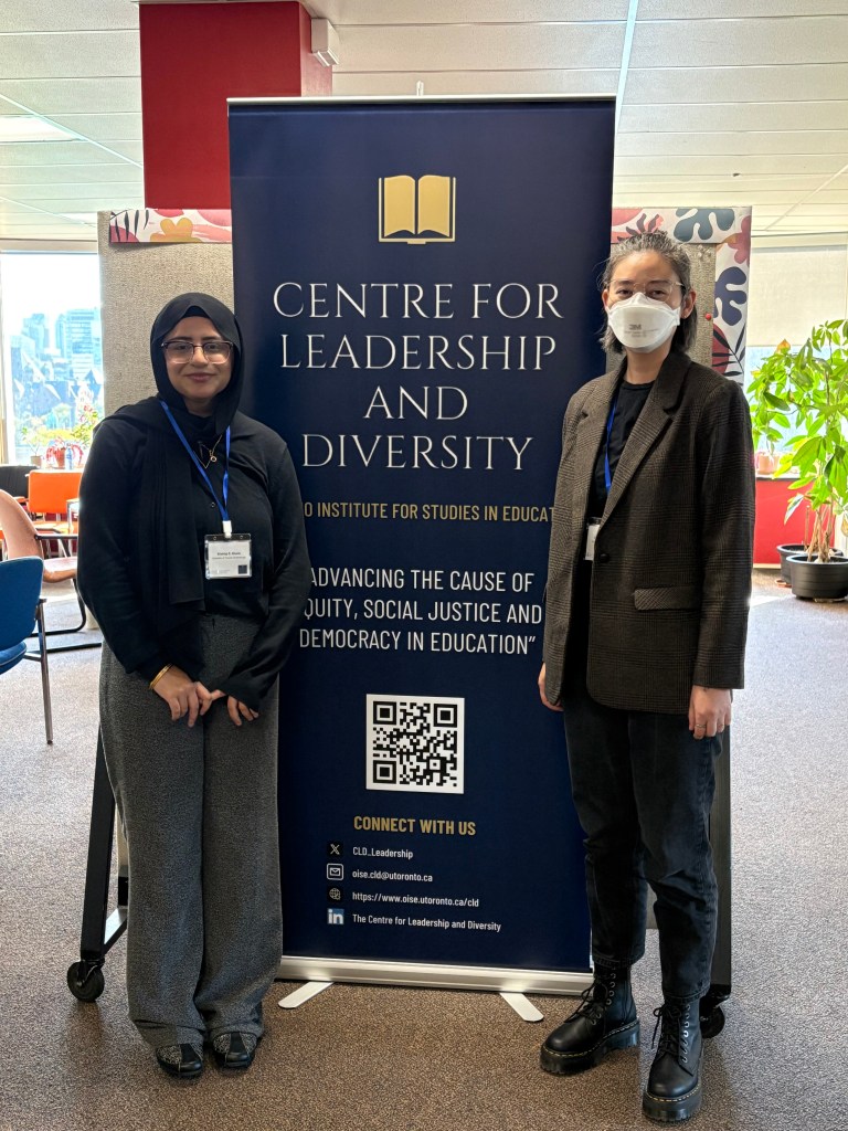 Shahtaj and Debra standing in front of a sign advertising the Centre for Leadership and Diversity 6th annual conference.